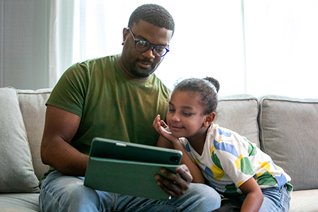 Father and daughter on tablet